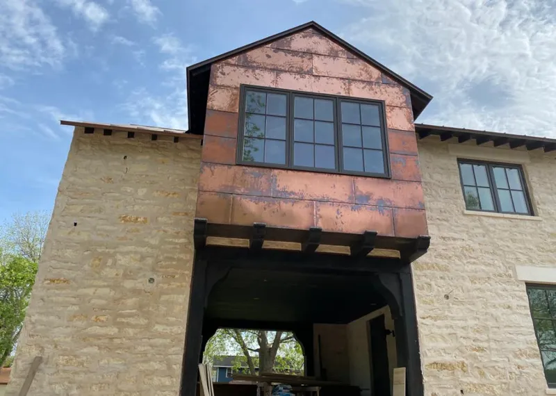 Copper metal panel facade on a stone building for Skylight Installation in West Bridgewater